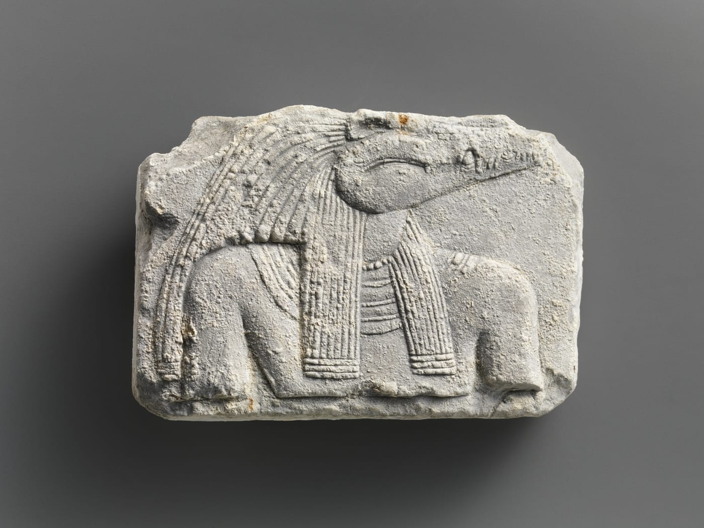 Egyptian relief plaque showing the upper body of a crocodile-headed deity (Sobek), Metropolitan Museum of Art.