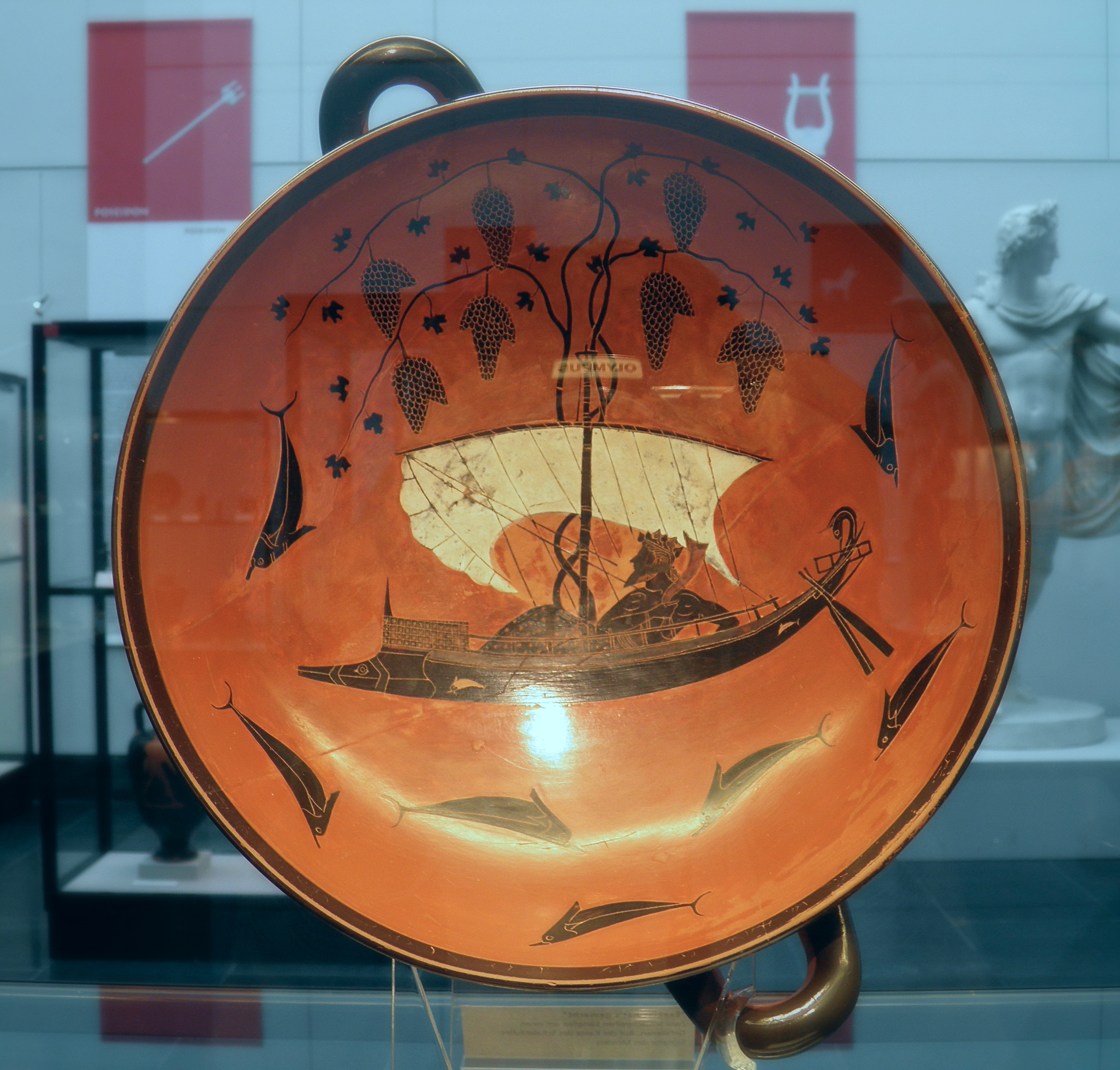Attic black-figure kylix by Exekias, c. 530 BCE, showing Dionysus reclining on a ship whose mast sprouts grapevines, surrounded by dolphins leaping in the sea.
