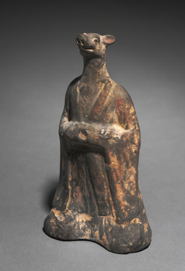 Grey earthenware tomb figure of a robed human body with a boar's head, hands clasped in front, from Northern Wei China.