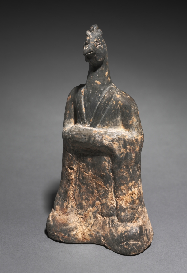Grey earthenware tomb figure of a standing human body in long robes with the head of a cock, complete with comb and beak, from Northern Wei China.
