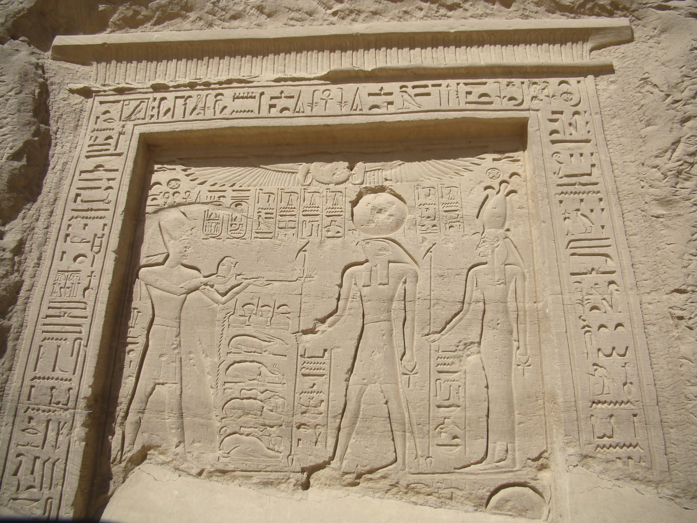 Ancient Egyptian relief from the Temple of Nekhbet at El Kab showing Ramesses II making an offering before the vulture goddess Nekhbet.