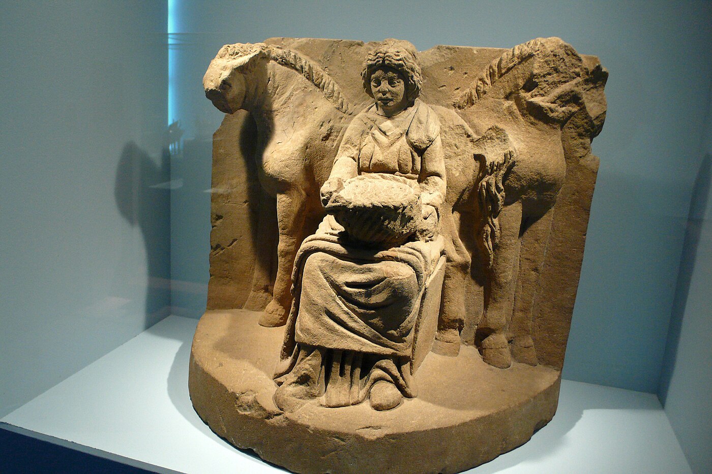 Roman-period votive relief of the Celtic horse goddess Epona seated between two horses, c. 200 CE, from Köngen, Baden-Württemberg, photographed at the Historisches Museum Bern.