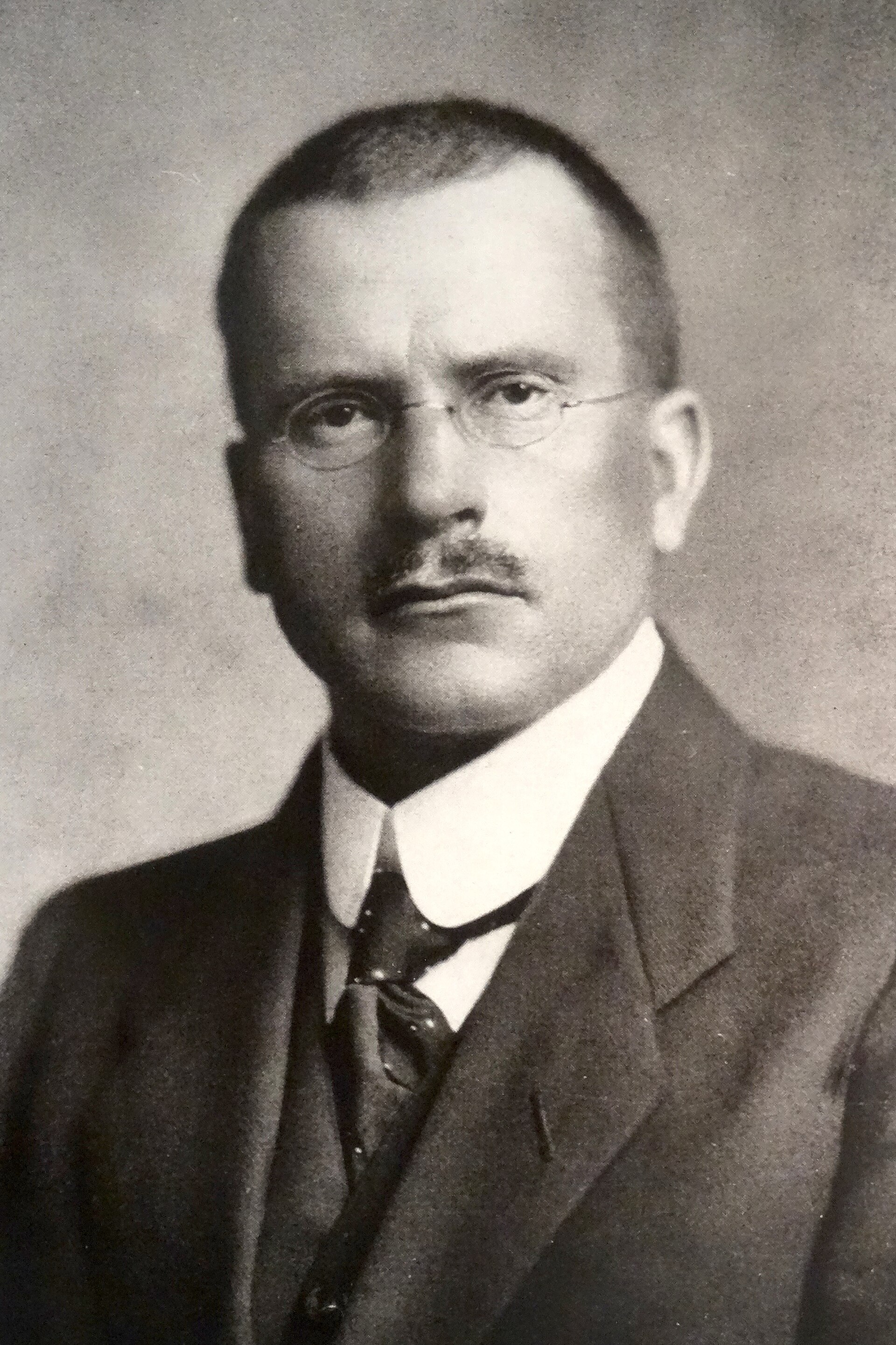 Carl Jung seated at his desk in Küsnacht, c. 1910, photographed in his study at the Burgholzli psychiatric clinic, Zurich.