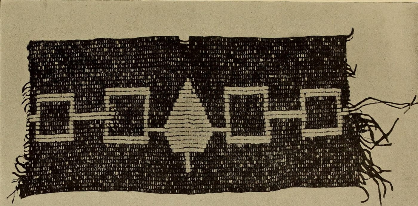 The Hiawatha Wampum Belt, a diplomatic record of the founding of the Haudenosaunee Confederacy, showing five symbols representing the founding nations joined by a central fire symbol, held by the Onondaga Nation.